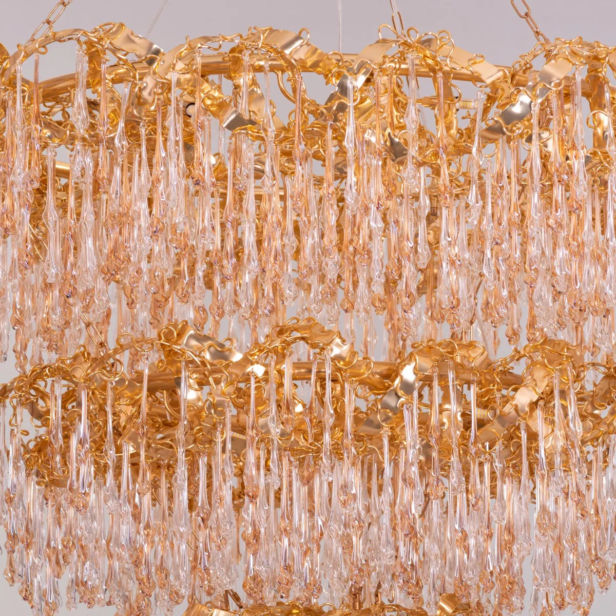 Large gold 3-layer crystal chandelier resembling a sparkling galaxy