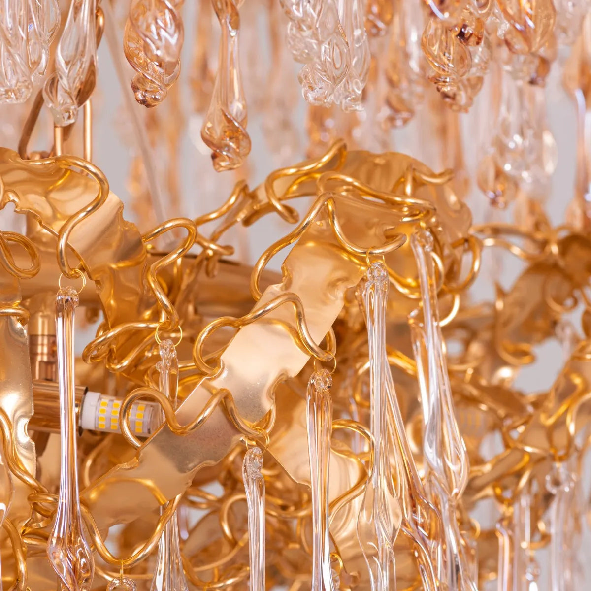 Large gold 3-layer crystal chandelier resembling a sparkling galaxy