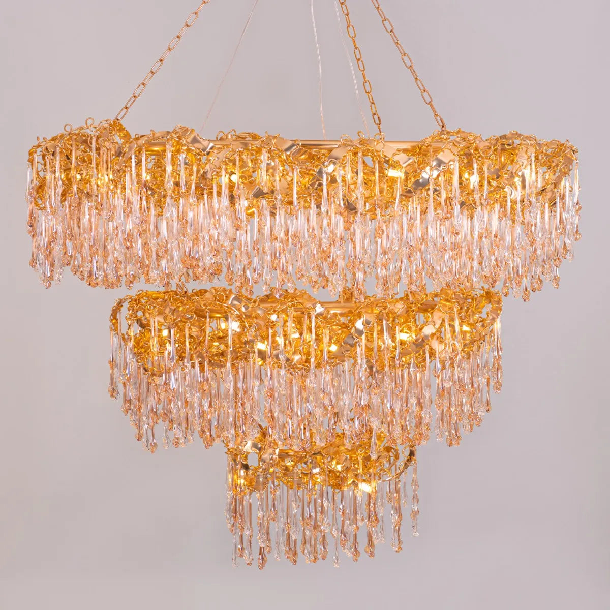 Large gold 3-layer crystal chandelier resembling a sparkling galaxy