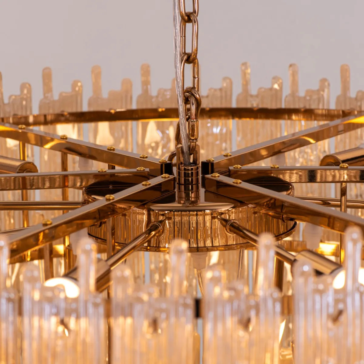 Breakfast In Bed Chandelier suspended above a luxurious dining table, its gold and crystal elements creating a warm, inviting glow.