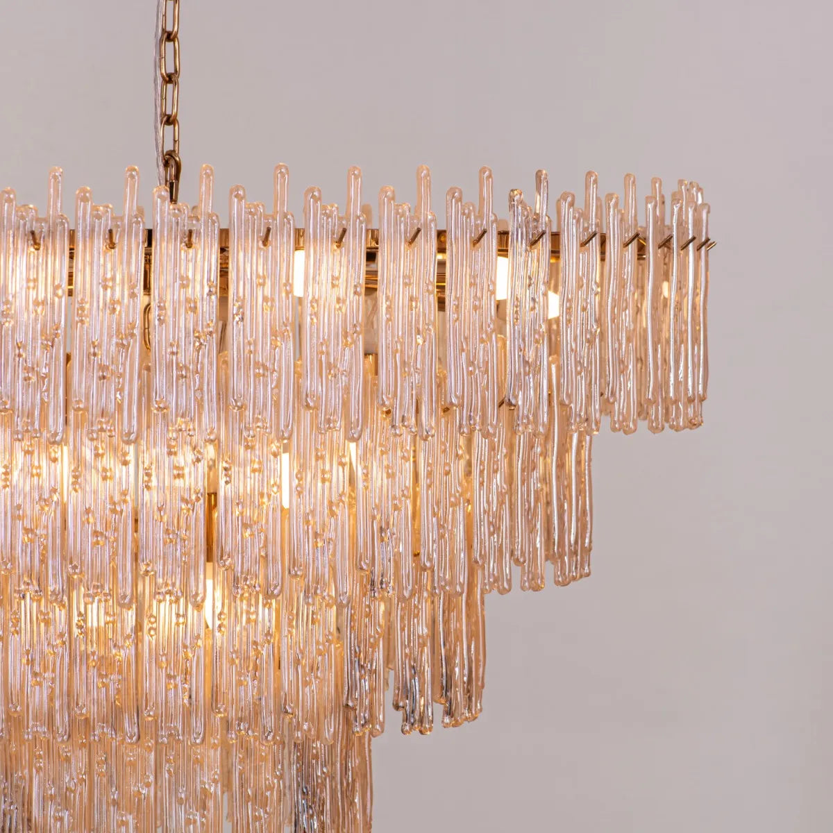 Breakfast In Bed Chandelier suspended above a luxurious dining table, its gold and crystal elements creating a warm, inviting glow.