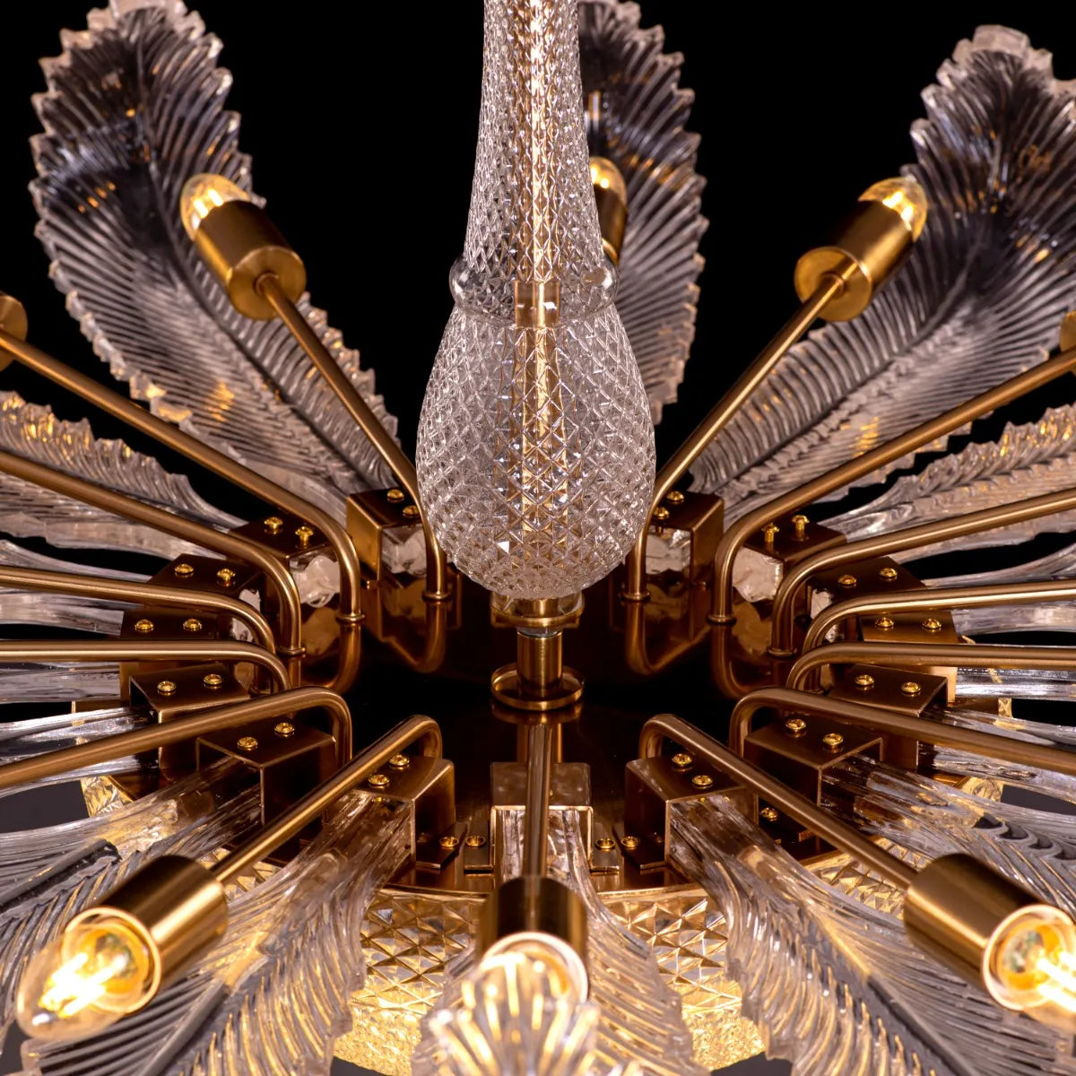 Large gold crystal chandelier with intricate design, hanging in an opulent room