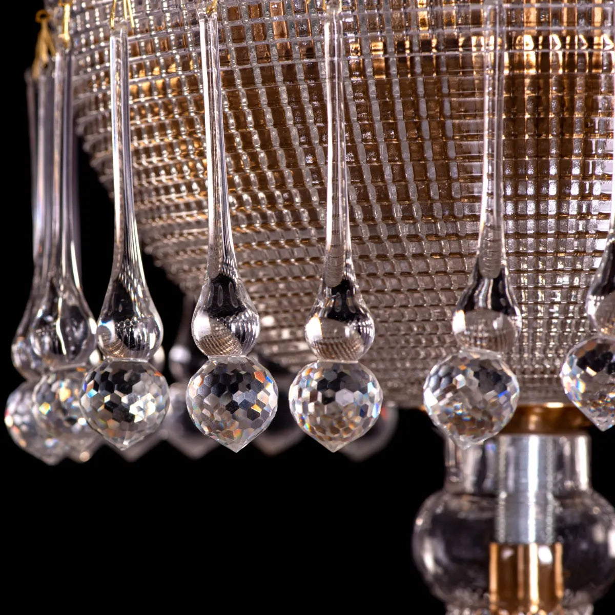 Large gold crystal chandelier with intricate design, hanging in an opulent room