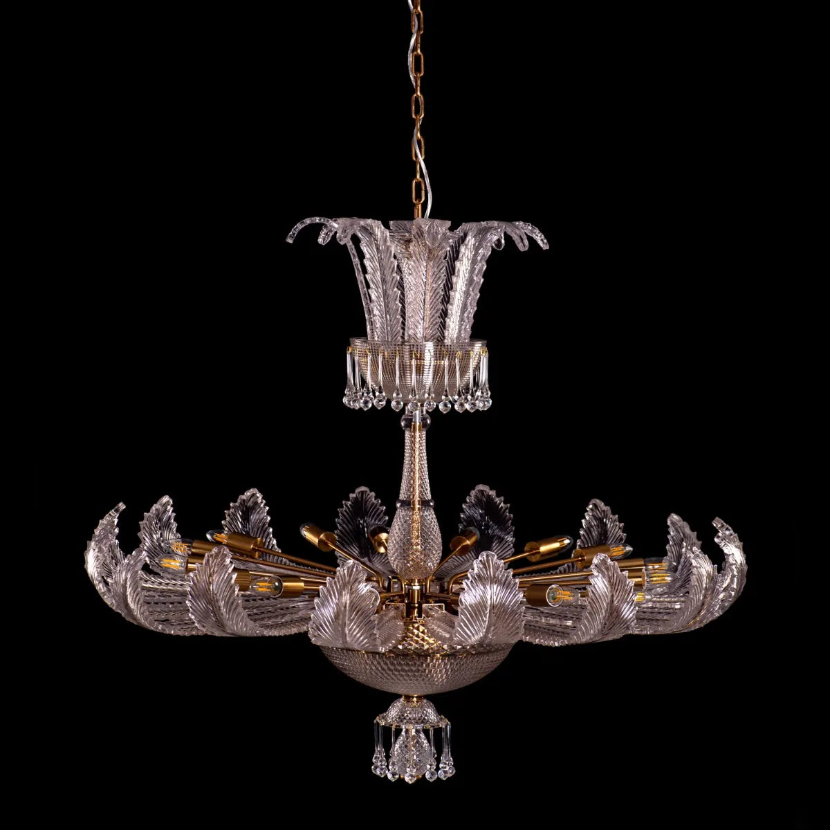 Large gold crystal chandelier with intricate design, hanging in an opulent room