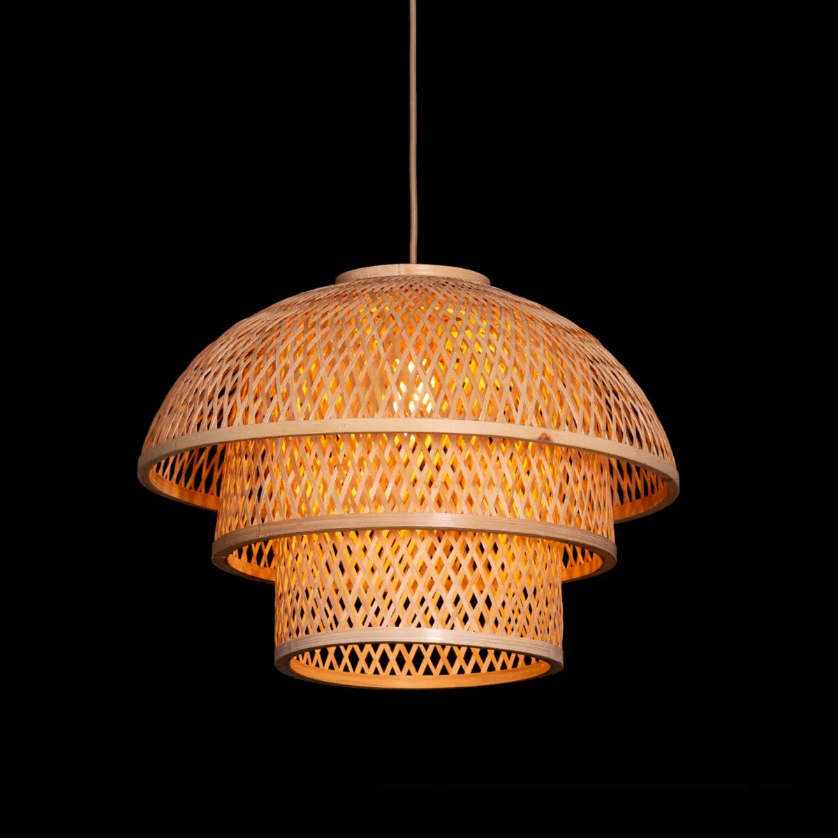 A unique rattan pendant light named 'Never The Same,' featuring a handcrafted, woven rattan shade with an organic, irregular shape. The natural fibers create a warm, inviting glow as light filters through the intricate patterns, offering a bohemian, rustic charm that adds texture and character to any space.