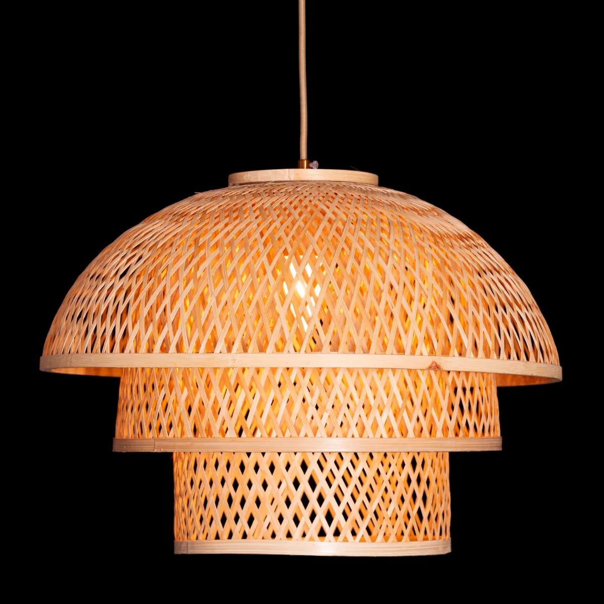 A unique rattan pendant light named 'Never The Same,' featuring a handcrafted, woven rattan shade with an organic, irregular shape. The natural fibers create a warm, inviting glow as light filters through the intricate patterns, offering a bohemian, rustic charm that adds texture and character to any space.