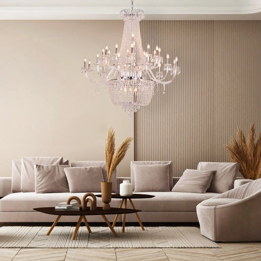 Large chrome crystal chandelier with letter-shaped elements, hanging in a luxurious living room