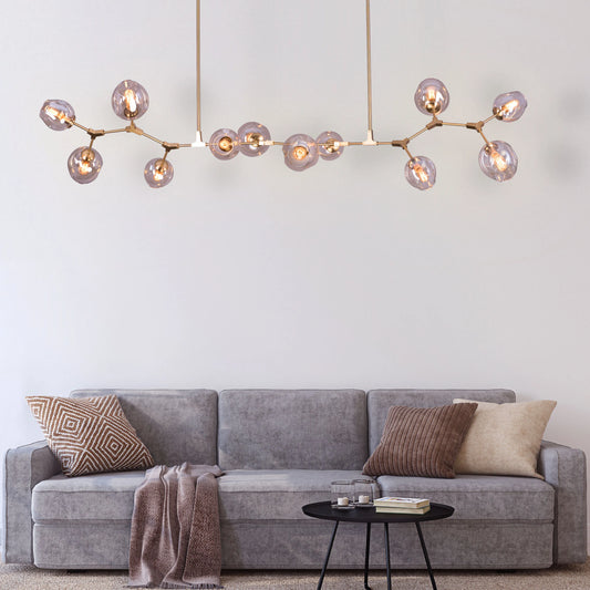 Games People Play large gold chandelier with 12 cognac glass heads illuminating a stylish living room