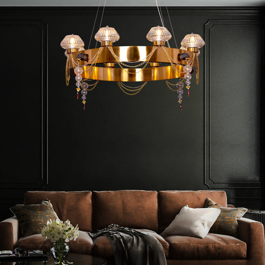 Large "Heart Is Beating" gold and clear glass chandelier, illuminated and suspended in a spacious, elegant room.