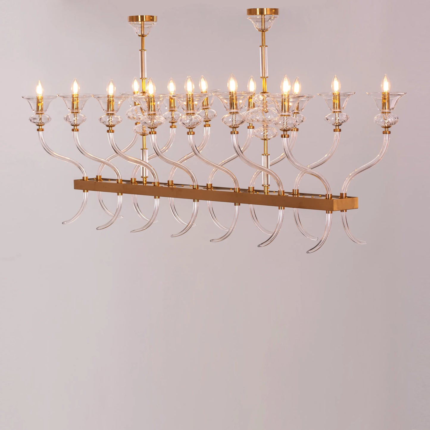 Large gold chandelier with clear glass for luxury interiors.