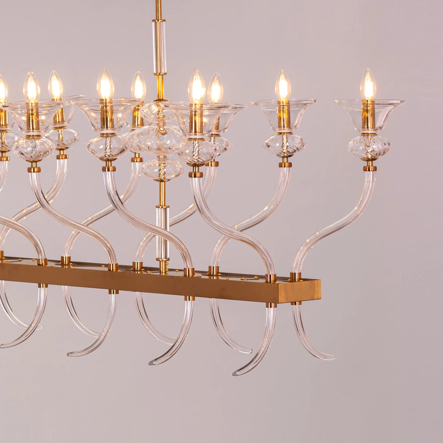 Large gold chandelier with clear glass for luxury interiors.