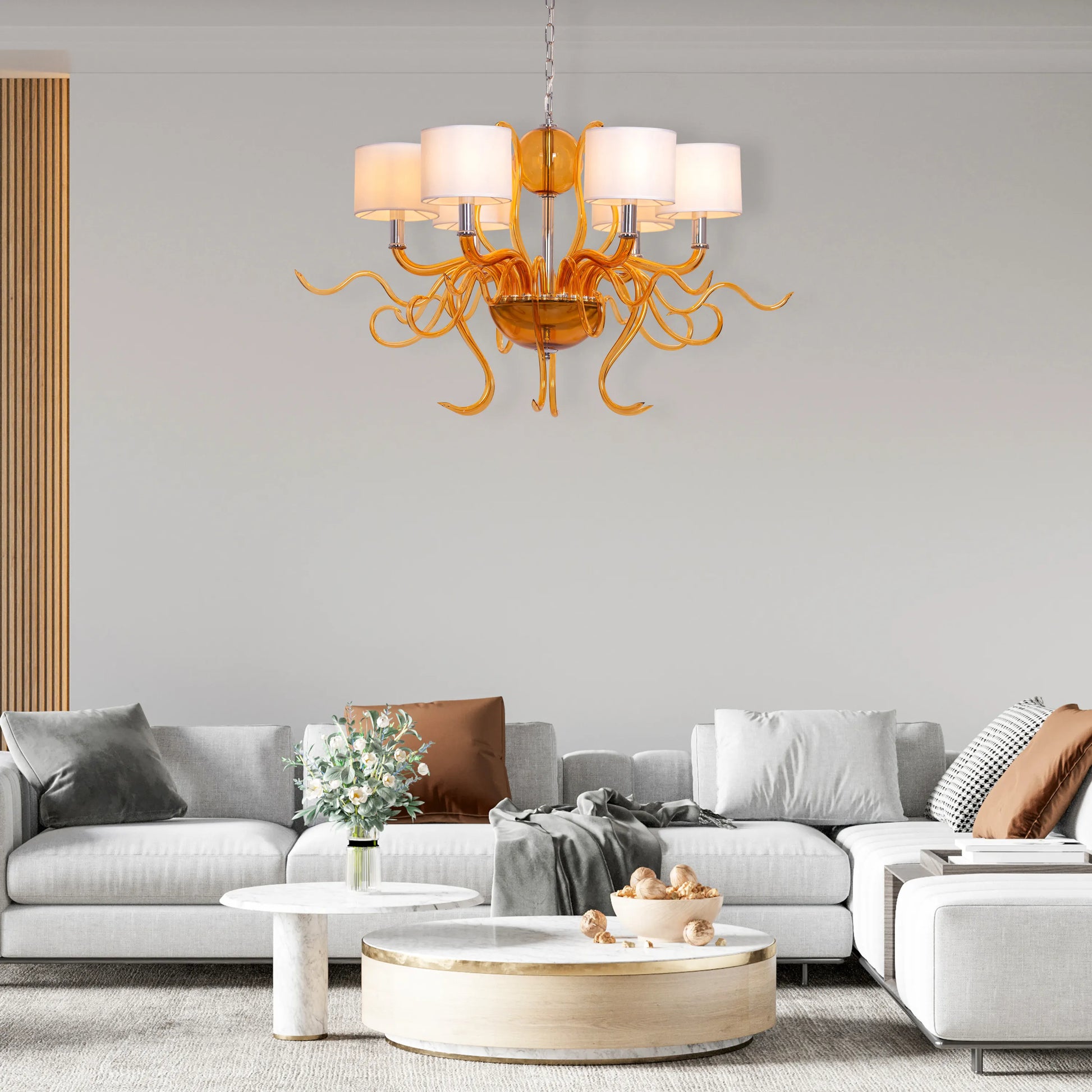 Large clear glass chandelier with chrome, amber, and white elements suspended in harmonious arrangement