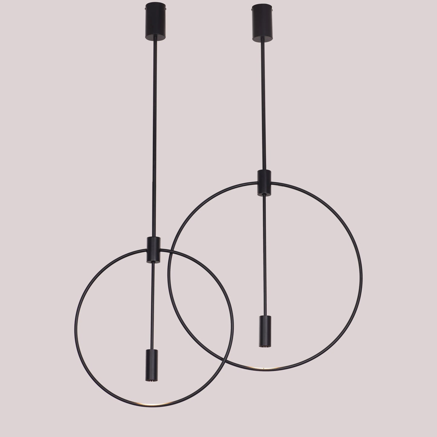 Ring On It Black Chandelier suspended in a modern living room, emitting a warm white glow