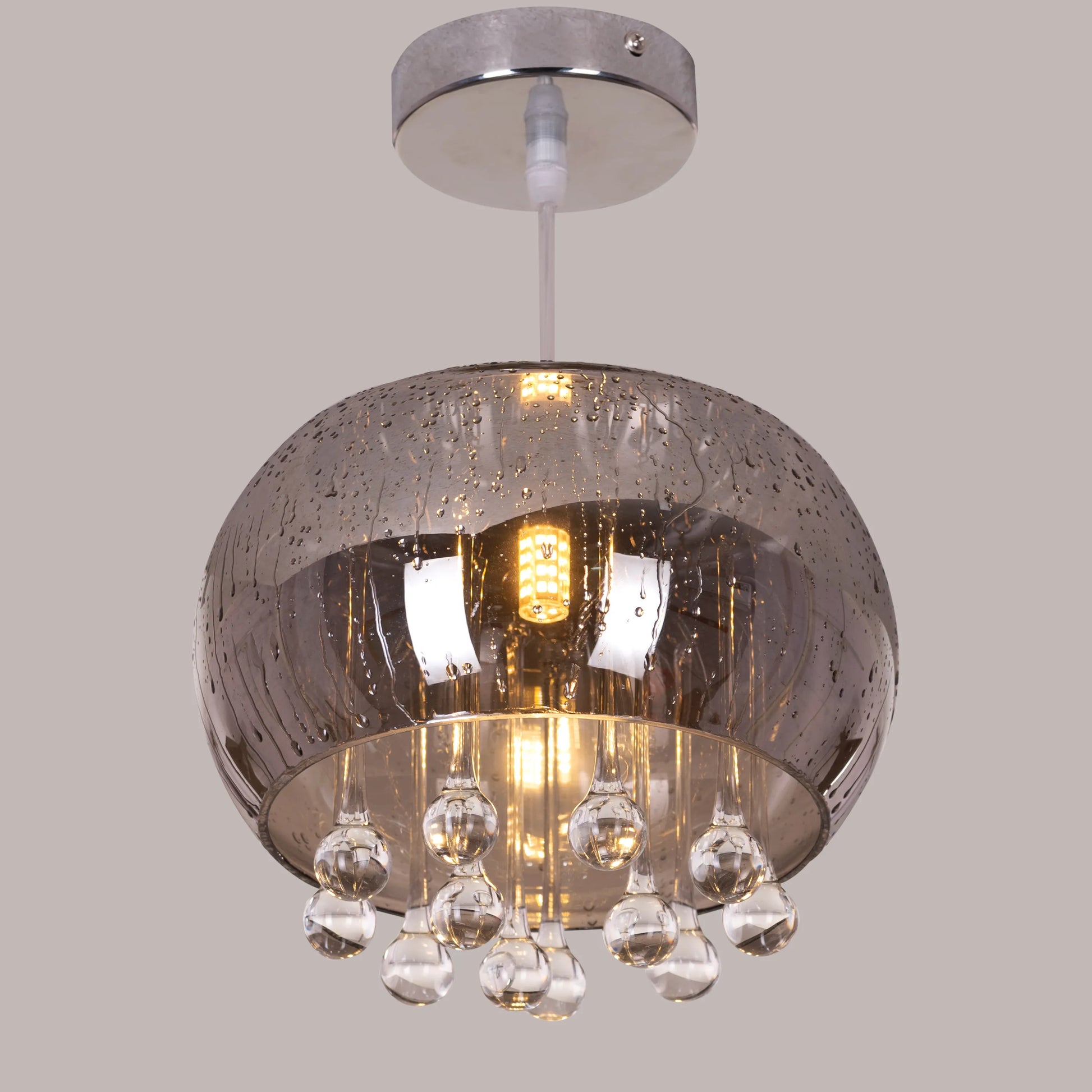 An elegant crystal pendant light featuring a mini waterdrop design in a mirror finish. The fixture showcases a luxurious combination of gold and black, with delicate crystal accents that shimmer in the light. Its sleek waterdrop shape and reflective surface create a modern, sophisticated look, adding a touch of enchantment and glamour to any space.