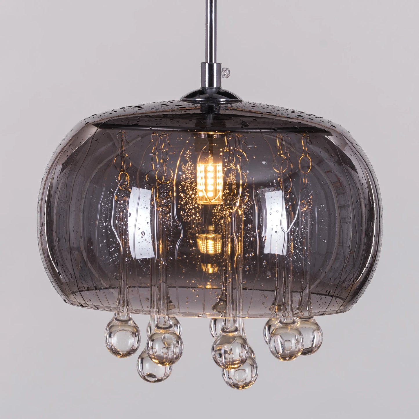 An elegant crystal pendant light featuring a mini waterdrop design in a mirror finish. The fixture showcases a luxurious combination of gold and black, with delicate crystal accents that shimmer in the light. Its sleek waterdrop shape and reflective surface create a modern, sophisticated look, adding a touch of enchantment and glamour to any space.