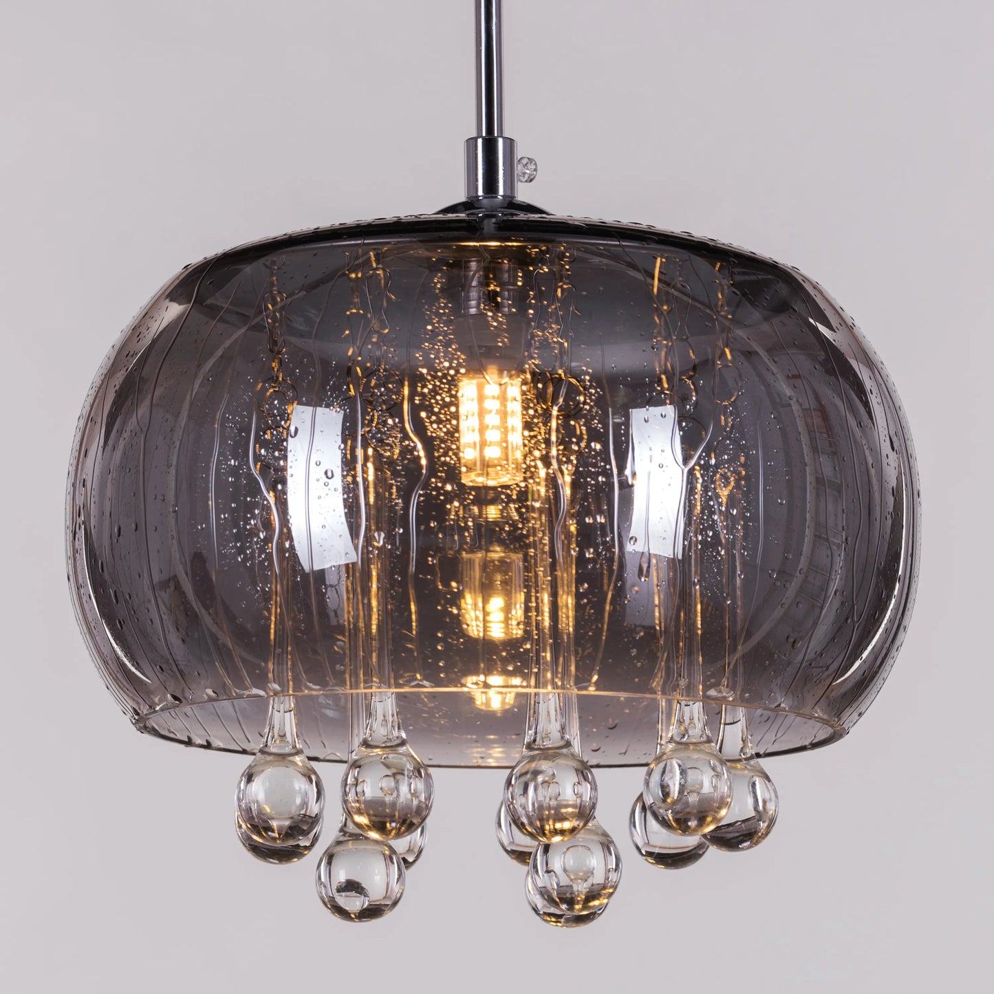 An elegant crystal pendant light featuring a mini waterdrop design in a mirror finish. The fixture showcases a luxurious combination of gold and black, with delicate crystal accents that shimmer in the light. Its sleek waterdrop shape and reflective surface create a modern, sophisticated look, adding a touch of enchantment and glamour to any space.