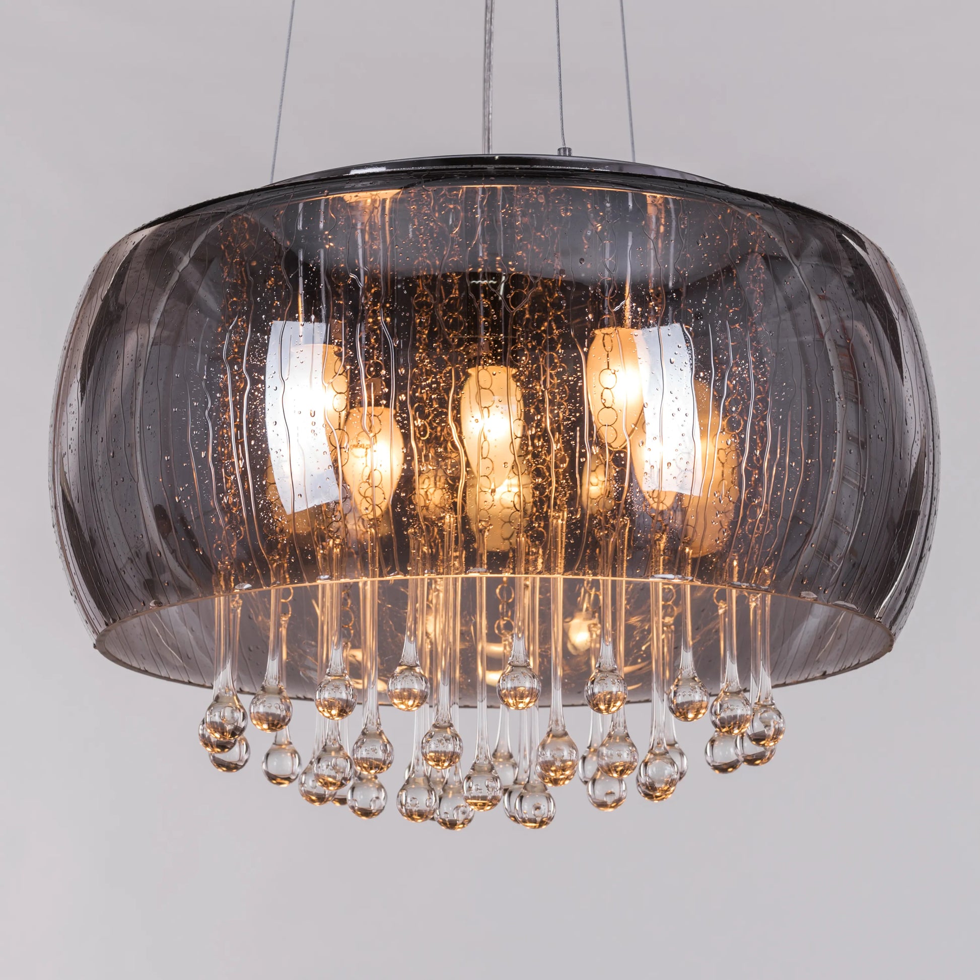 An elegant crystal pendant light featuring a mini waterdrop design in a mirror finish. The fixture showcases a luxurious combination of gold and black, with delicate crystal accents that shimmer in the light. Its sleek waterdrop shape and reflective surface create a modern, sophisticated look, adding a touch of enchantment and glamour to any space.