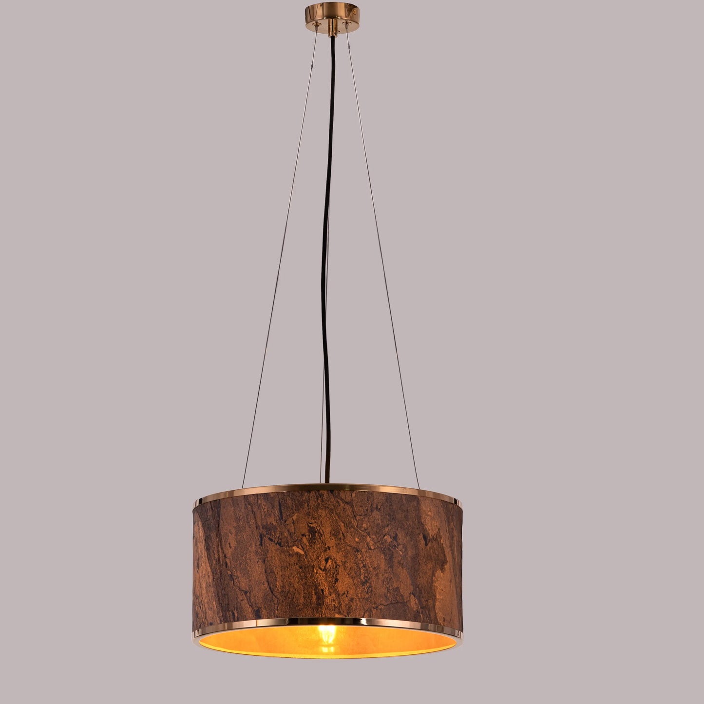 A contemporary pendant light named 'Touch & Glow,' featuring a striking gold stone veneer shade. The light's sleek design showcases the natural texture of the stone, beautifully reflecting and diffusing light to create a warm, inviting ambiance. This pendant light adds a touch of luxury and sophistication, making it an ideal choice for modern interiors.