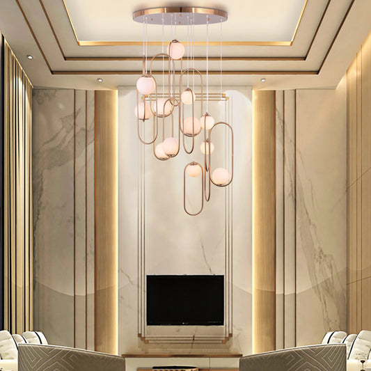 Large gold April In Paris chandelier with double-height design illuminating a luxurious Parisian-inspired living room