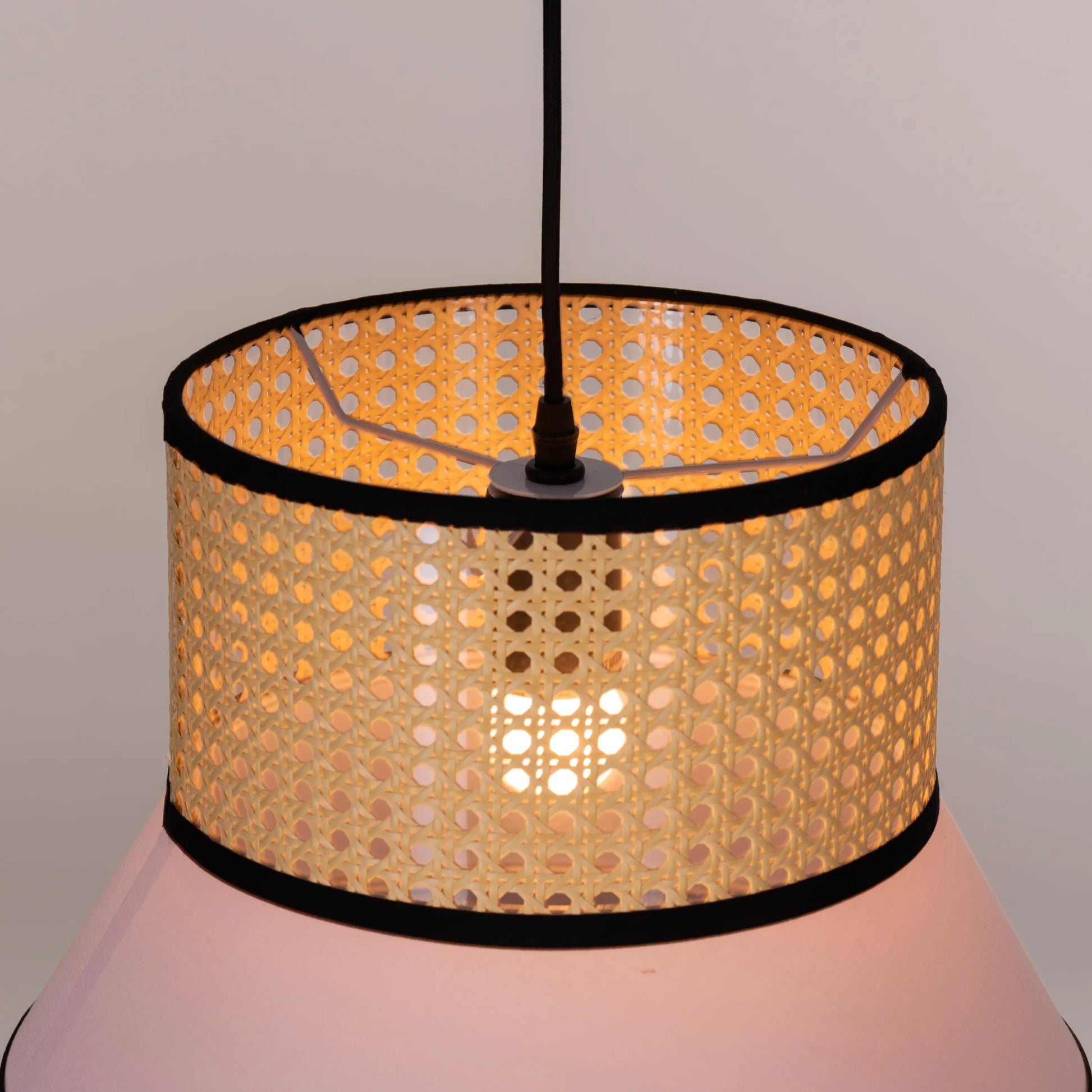 Make The Tea pink and blue rattan pendant light illuminating a modern dining room