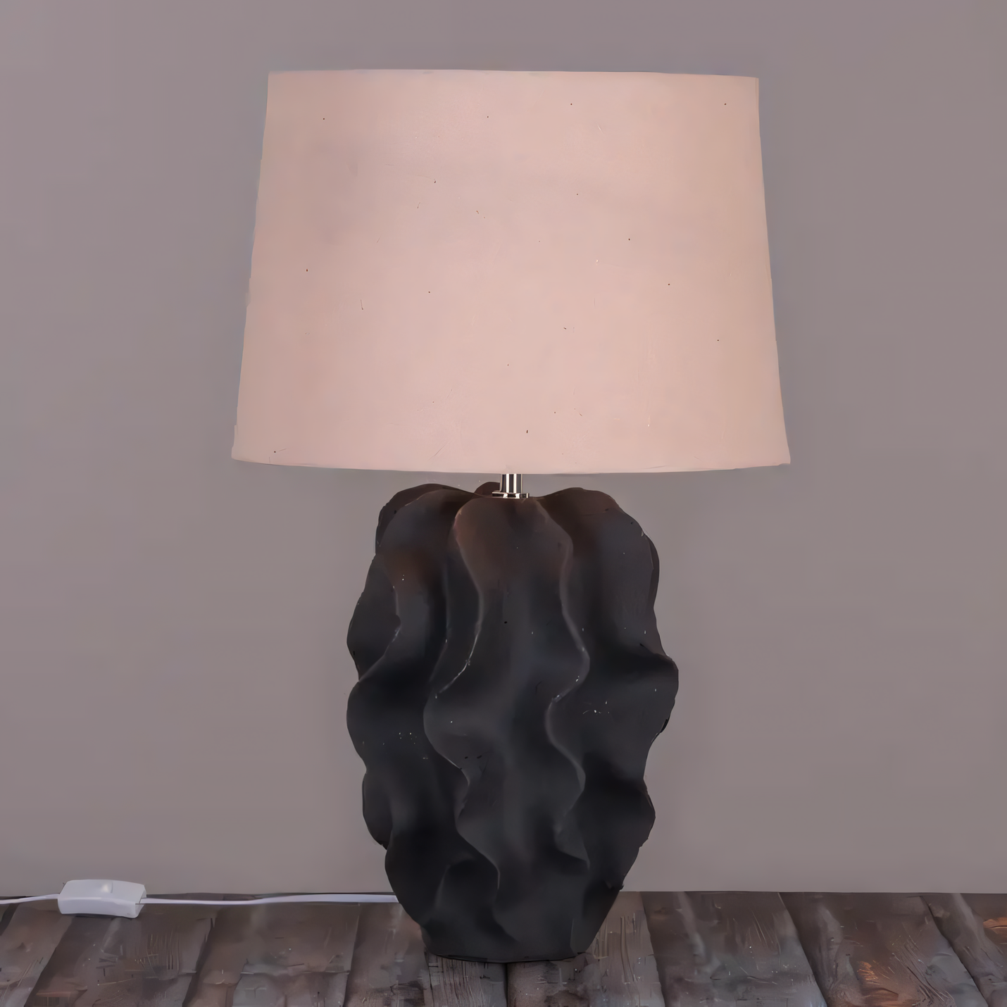 Volcanic-inspired ceramic table lamp with textured black base