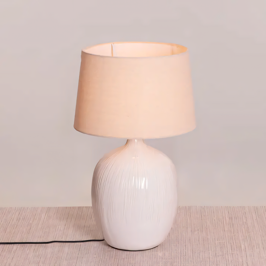 Off-white ceramic table lamp with beige fabric shade