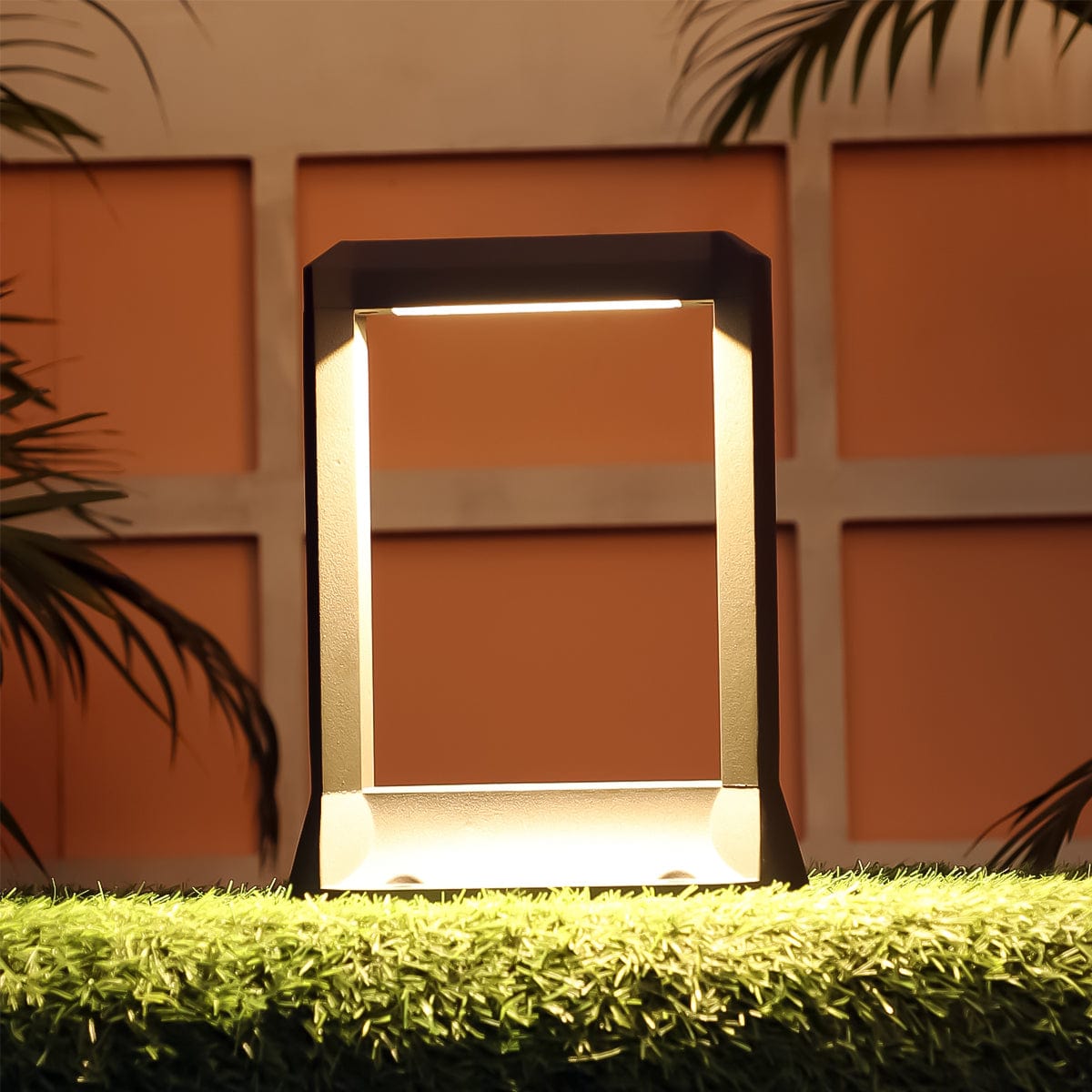 Minimalist hatch bollard light blending with organic landscapes