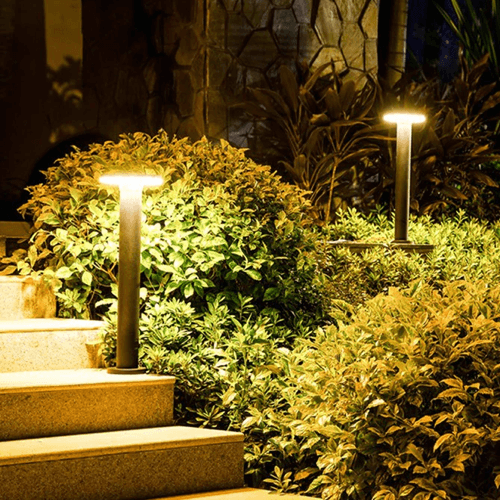 Circular bollard light with organic silhouette